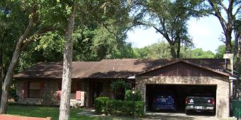 • Click for larger view of this Brown house with a half-brick front, brown roof and rust-colered trim •