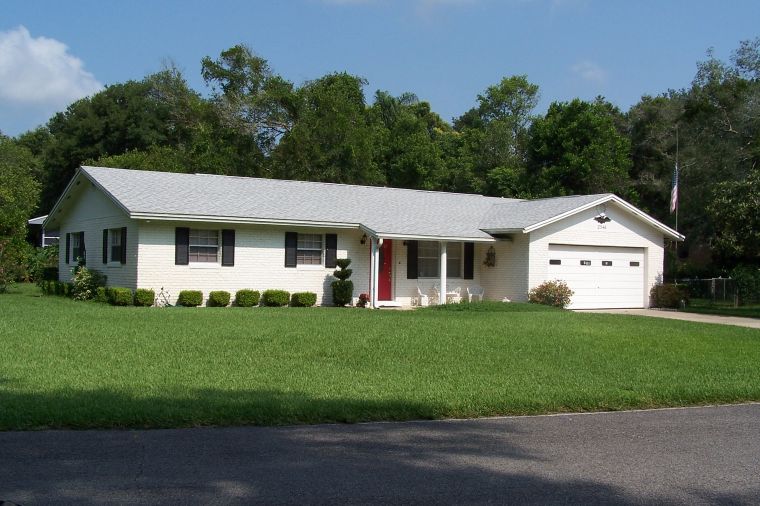 • Click for larger view of this White home with grey roof and beige half-brick front •