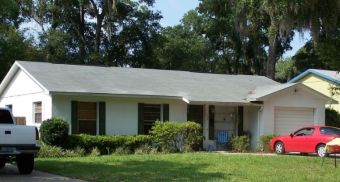 • Click for larger view of this White Home, with grey slate-colored roof, and black trim •