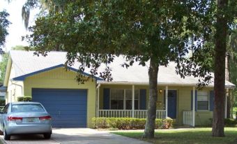 • Click for larger view of this Yellow Home, with a white roof, and blue trim •